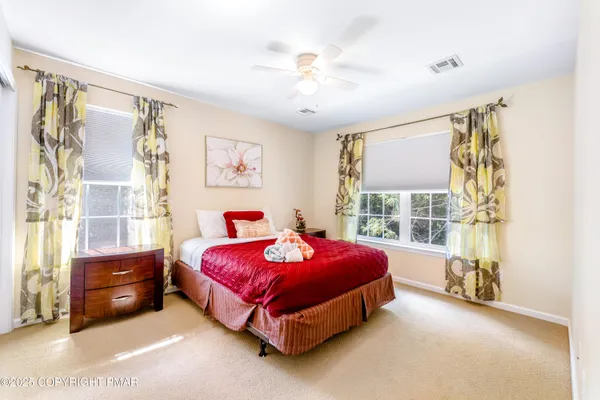 a spacious bedroom with a bed and a window