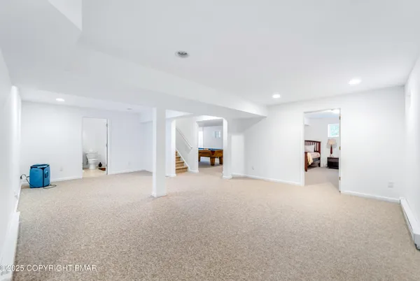 a view of empty room with furniture and kitchen