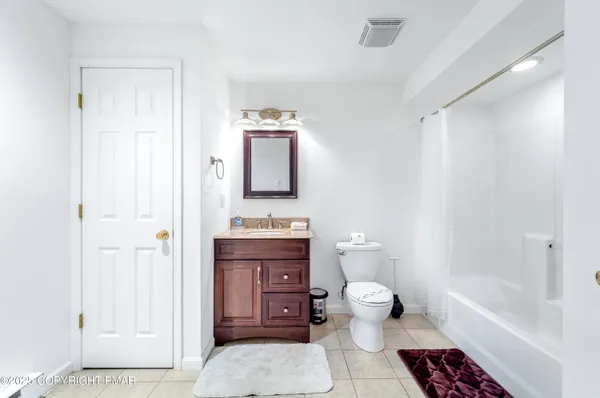 a bathroom with a toilet a sink and bathtub
