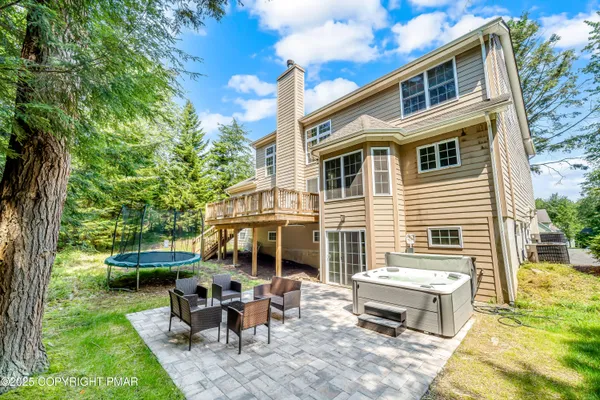 a view of a house with backyard sitting area and garden