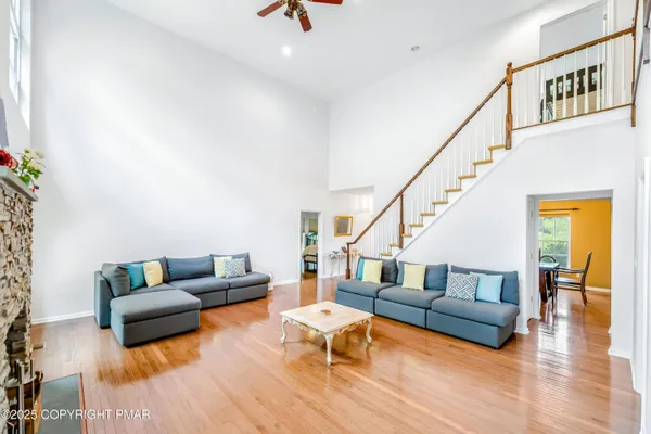 a living room with furniture and a wooden floor