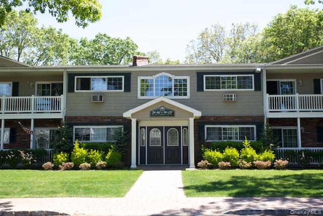 a front view of a house with a garden and plants