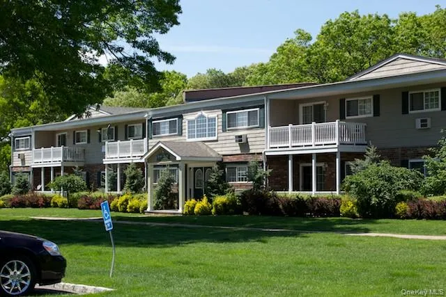 a front view of a house with a yard table and chairs