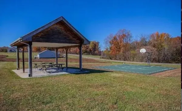 a view of a house with backyard and sitting area