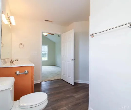 a bathroom with a granite countertop toilet sink and shower
