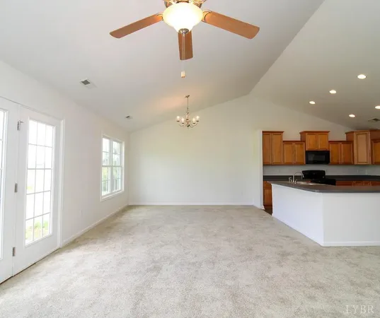 an empty room with windows and cabinet