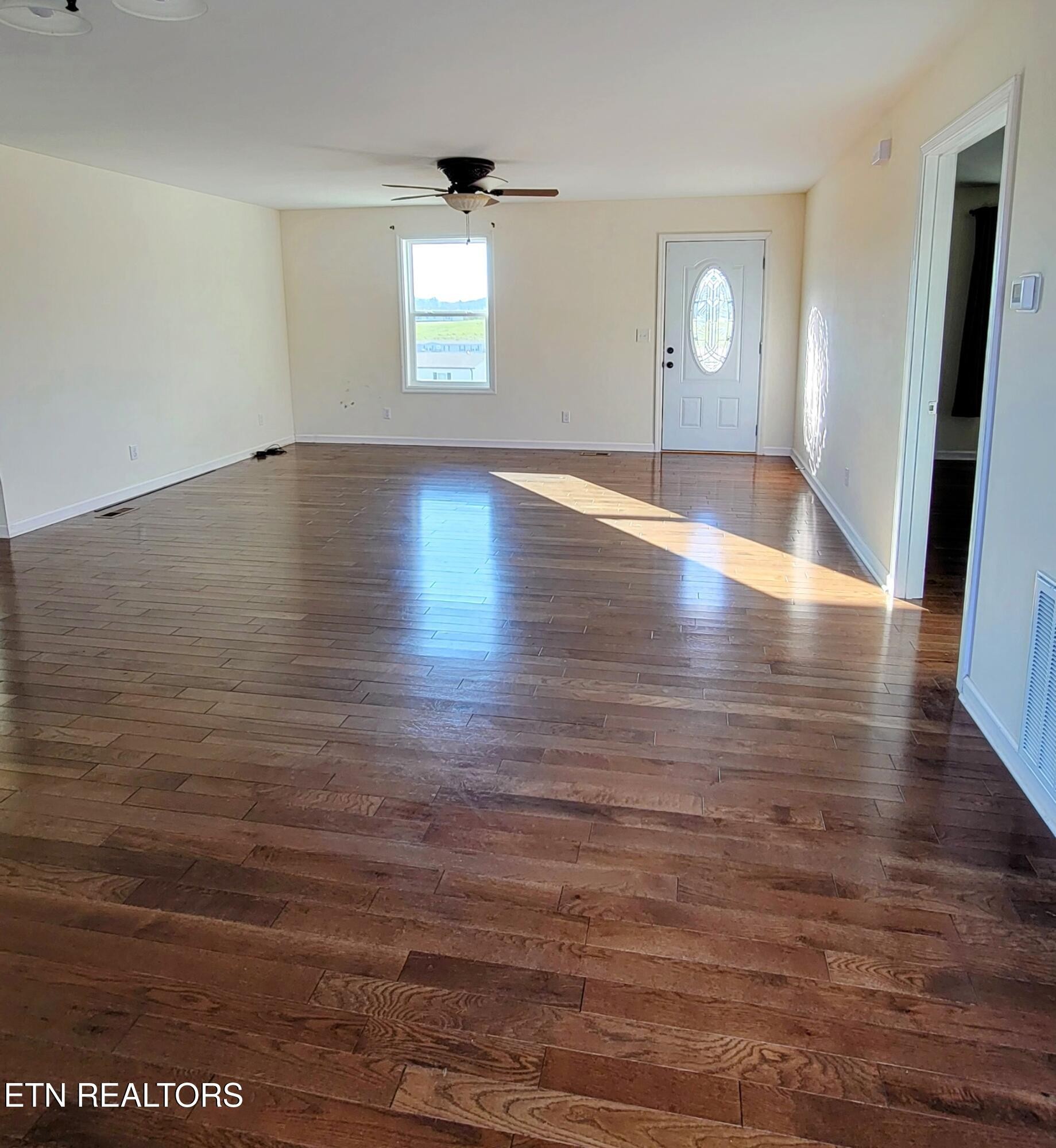 1571 Howell River Road Rutledge, TN 37861 - Photo 3 of 11 an empty room with wooden floor and windows