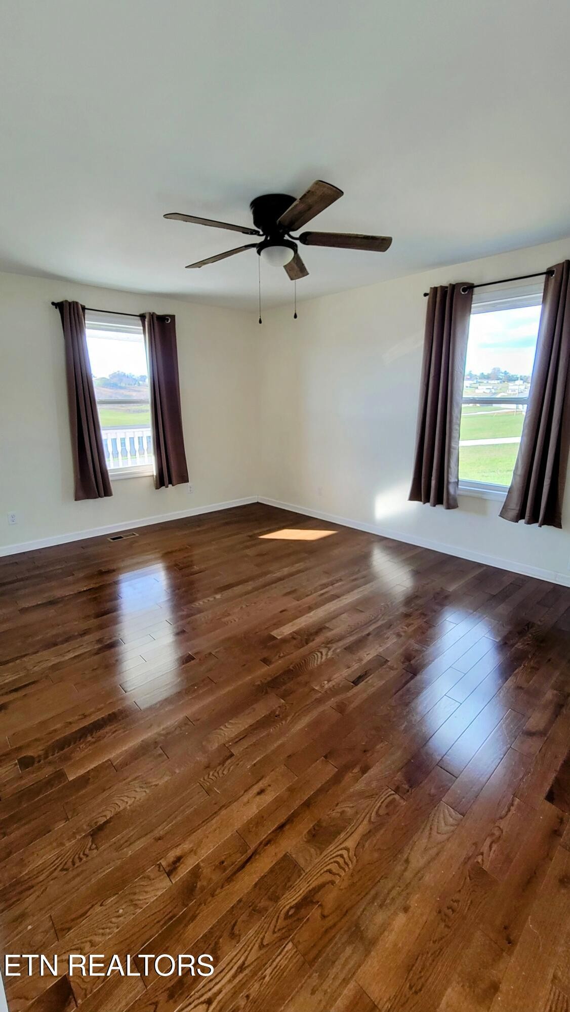 1571 Howell River Road Rutledge, TN 37861 - Photo 4 of 11 an empty room with wooden floor and windows