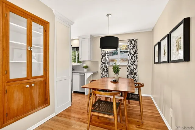 a view of a dining room with furniture wooden floor and chandelier