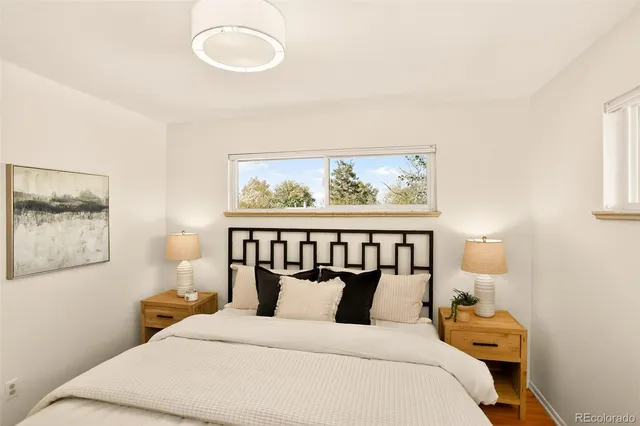 a bedroom with a bed and a painting on the wall