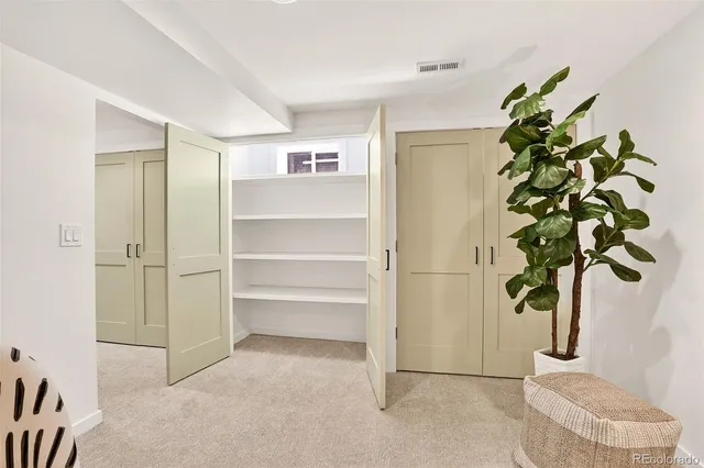 a vase of flowers sitting on a floor