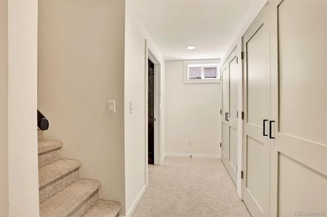 a view of a hallway with wooden floor and glass door