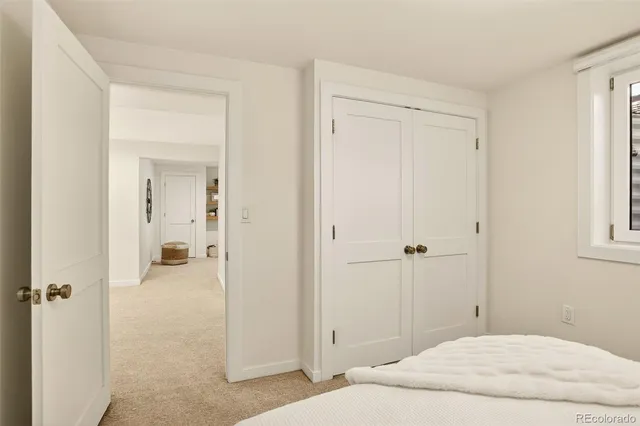 a bedroom with a bed and a mirror