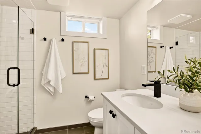 a bathroom with a sink a toilet and mirror