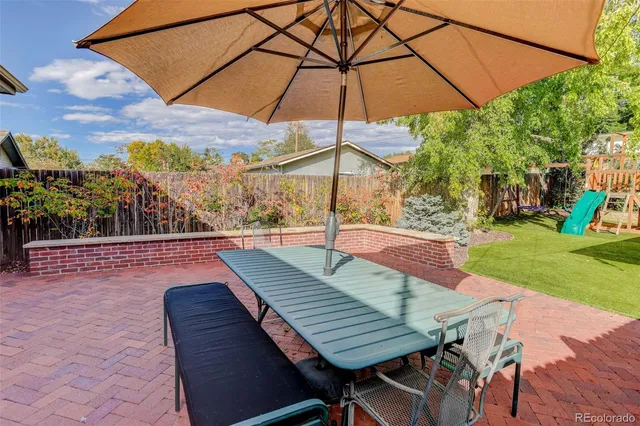 a view of an outdoor sitting area with furniture and umbrella