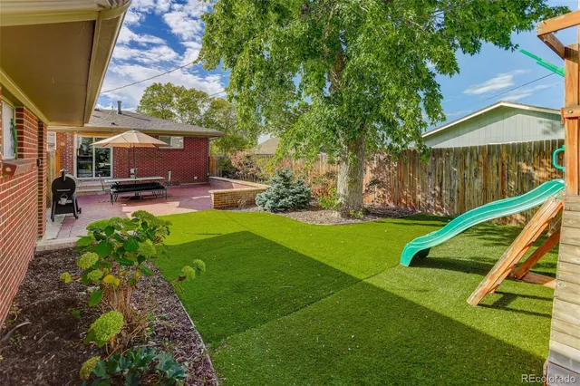 a view of a backyard with sitting area