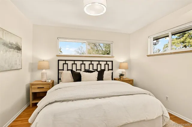 a bedroom with a bed and wall painting