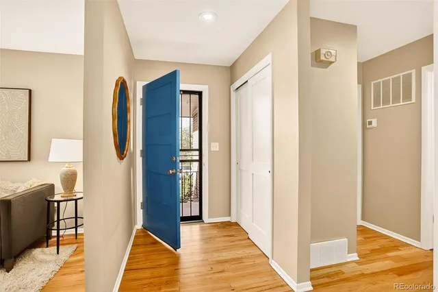 a view of hallway with furniture and wooden floor