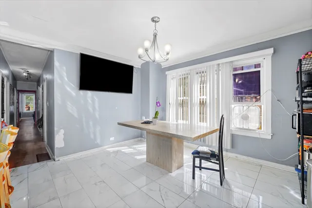 a living room with furniture a flat screen tv and a chandelier
