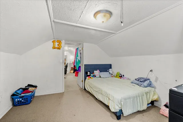 a bedroom with a bed and a tv