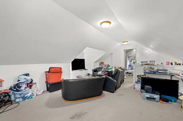 a living room with lots of furniture and clutter