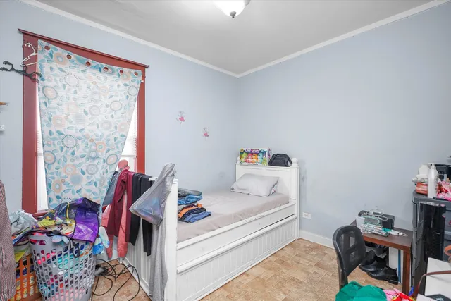 a bedroom with a bed and a chandelier