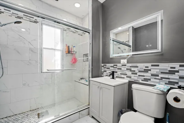 a front view of a house with a chairs and table in a patio