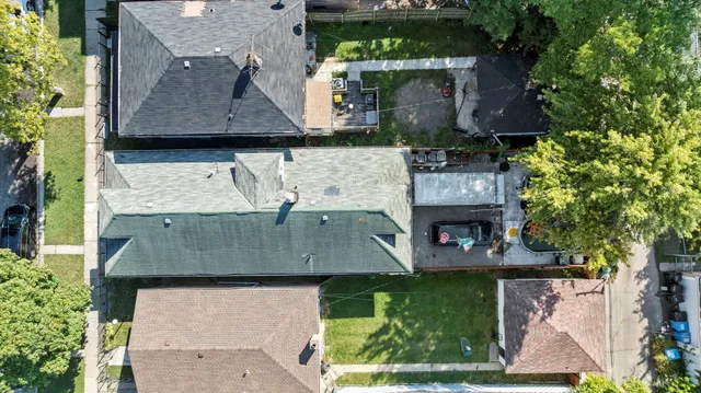 an aerial view of a house with a yard swimming pool and outdoor seating