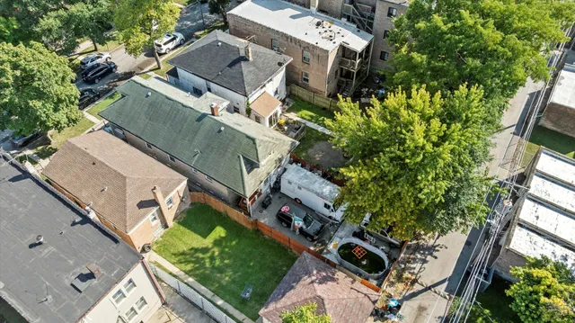 an aerial view of residential house with outdoor space and trees