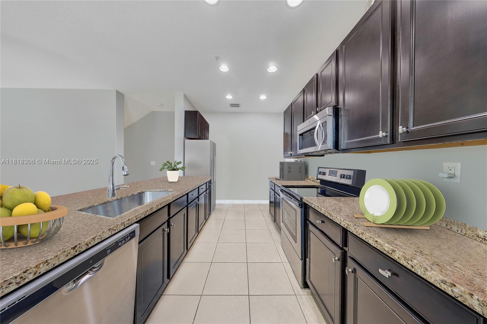14776 Southwest 10th Street, Unit 10501 Pembroke Pines, FL 33027 - Photo 2 of 16 a large kitchen with granite countertop a sink and a stove