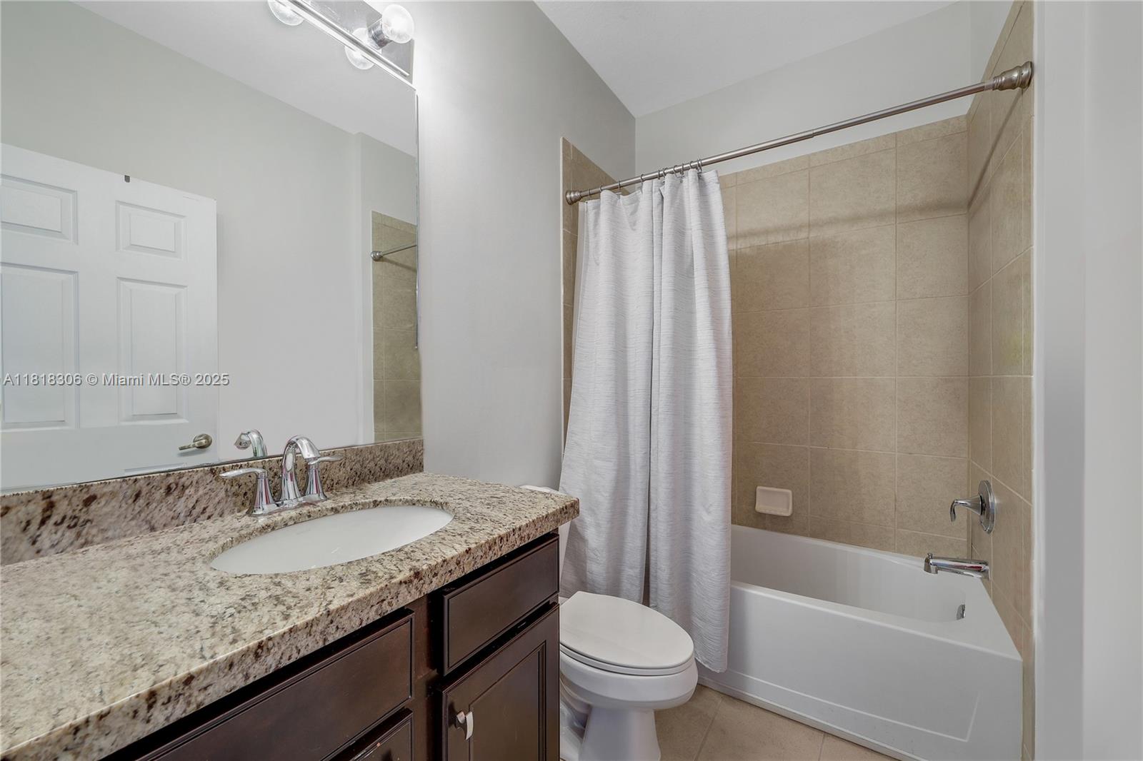 14776 Southwest 10th Street, Unit 10501 Pembroke Pines, FL 33027 - Photo 8 of 16 a bathroom with a granite countertop sink toilet and shower