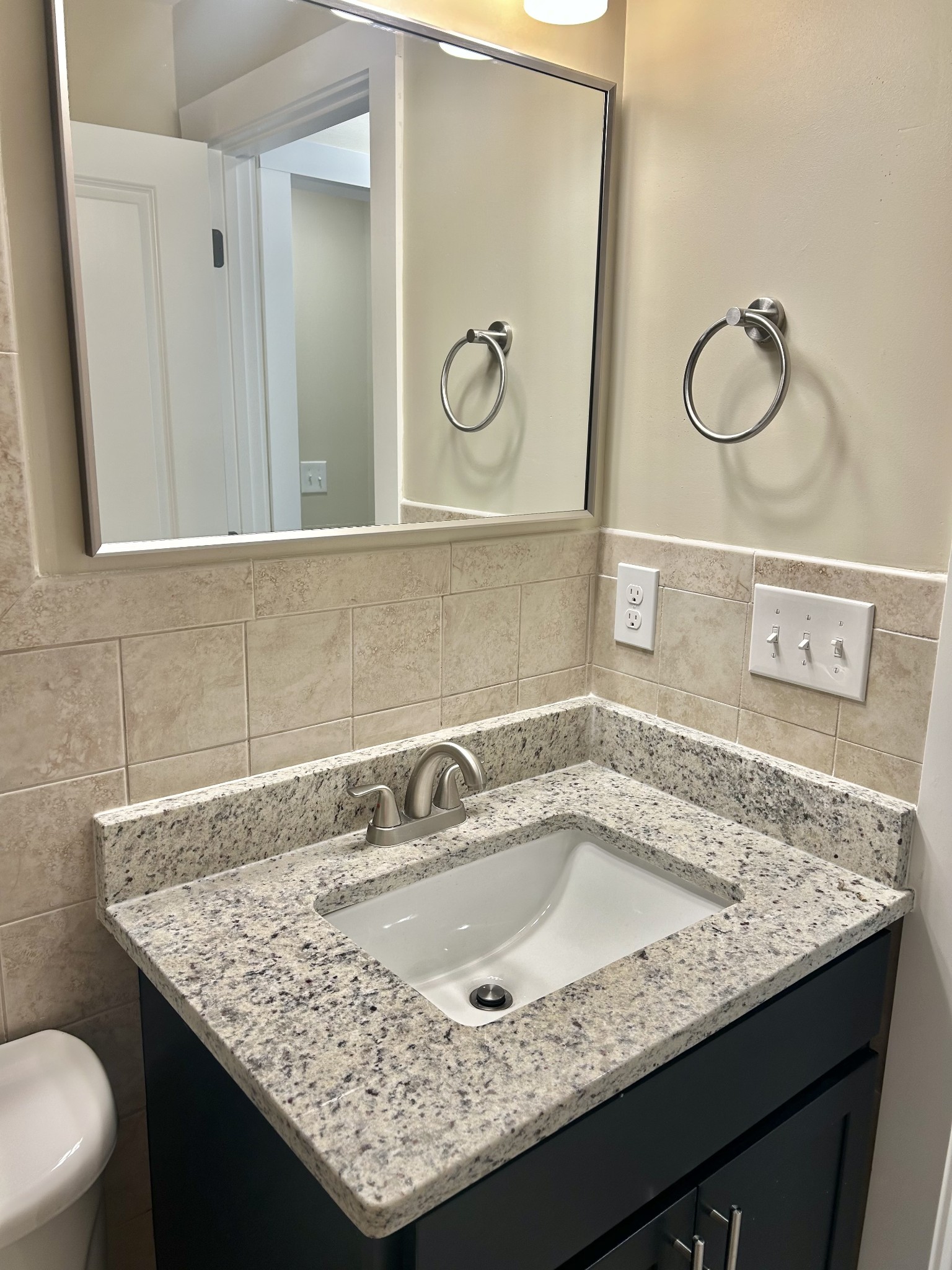 113 West Coffee Street Manchester, TN 37355 - Photo 12 of 31 a bathroom with a granite countertop sink and a mirror