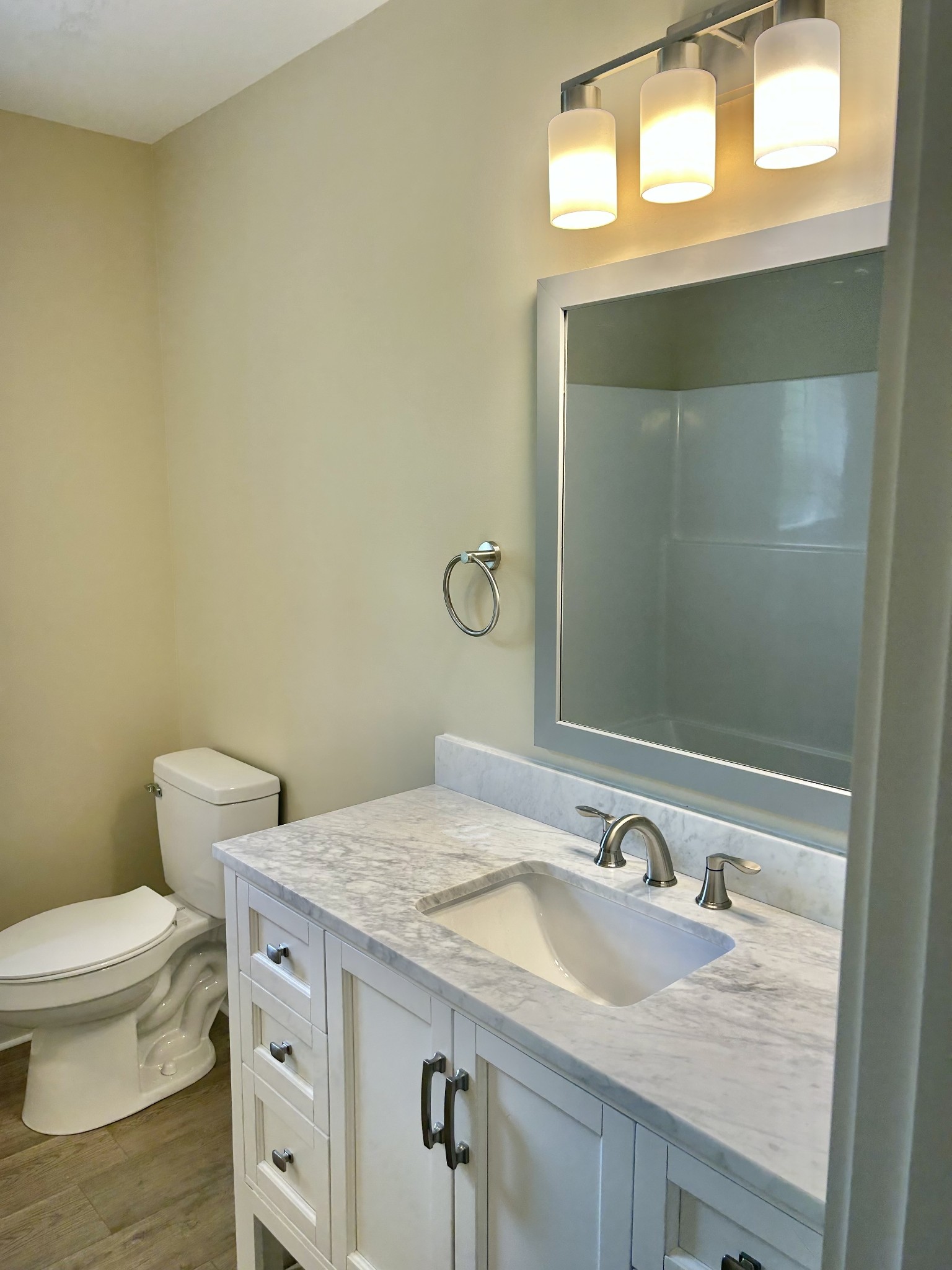113 West Coffee Street Manchester, TN 37355 - Photo 22 of 31 a bathroom with a granite countertop sink vanity mirror and toilet