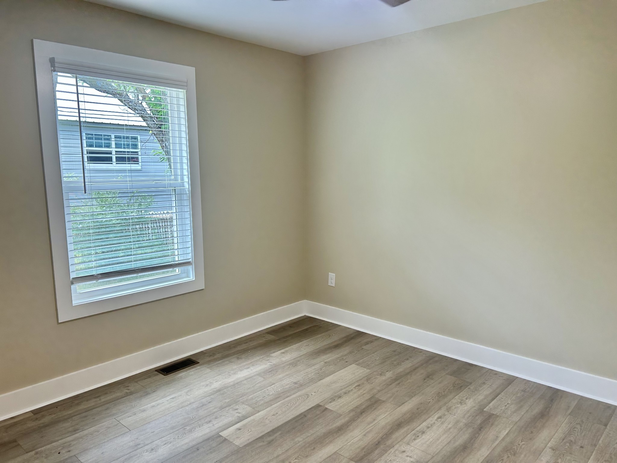 113 West Coffee Street Manchester, TN 37355 - Photo 26 of 31 an empty room with wooden floor and windows