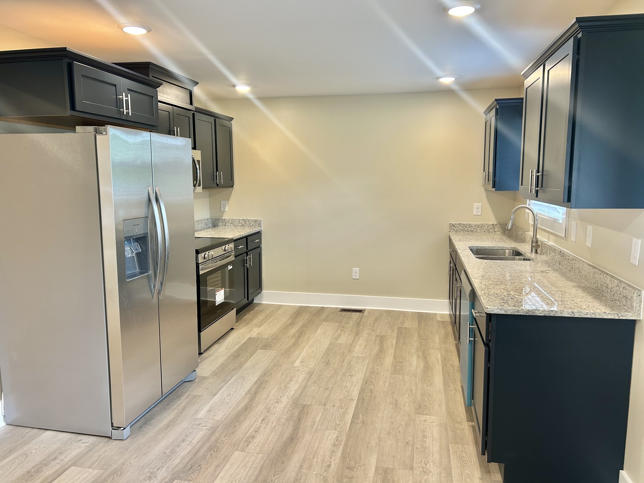113 West Coffee Street Manchester, TN 37355 - Photo 6 of 31 a kitchen with stainless steel appliances a refrigerator and a sink