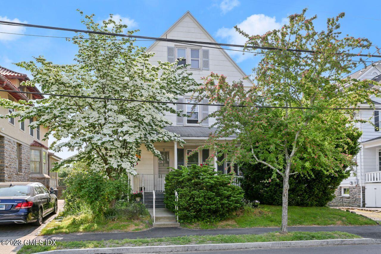 21 Ridge Street Greenwich, CT 06830 - Photo 11 of 15 a front view of a house with a yard and garage