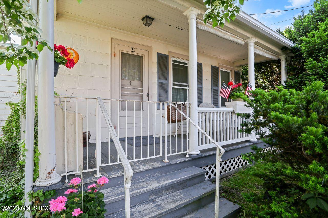 21 Ridge Street Greenwich, CT 06830 - Photo 2 of 15 a view of a house with wooden fence and potted plants
