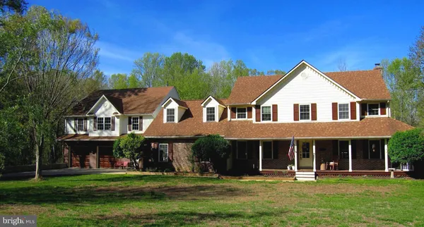 a kitchen with white cabinets stainless steel appliances and sink