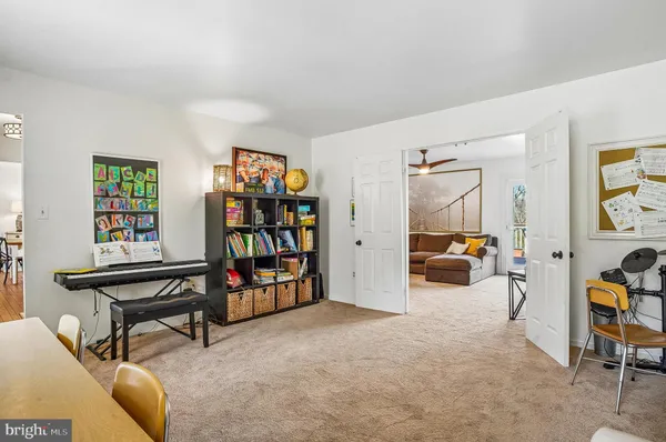 a kitchen with stainless steel appliances granite countertop a stove top oven a sink a dining table and chairs with wooden floor