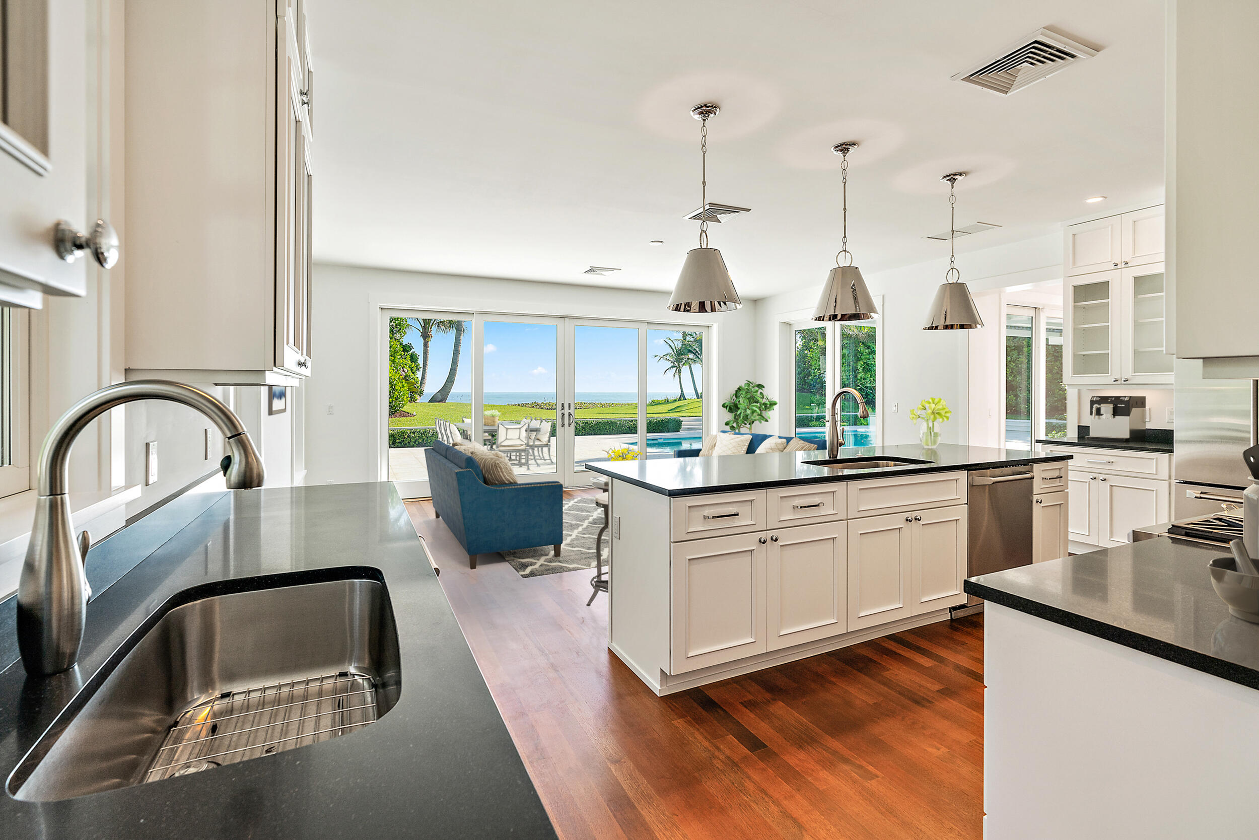 25 South Beach Road Hobe Sound, FL 33455 - Photo 13 of 28 a kitchen with stainless steel appliances granite countertop a sink a stove and a wooden floors