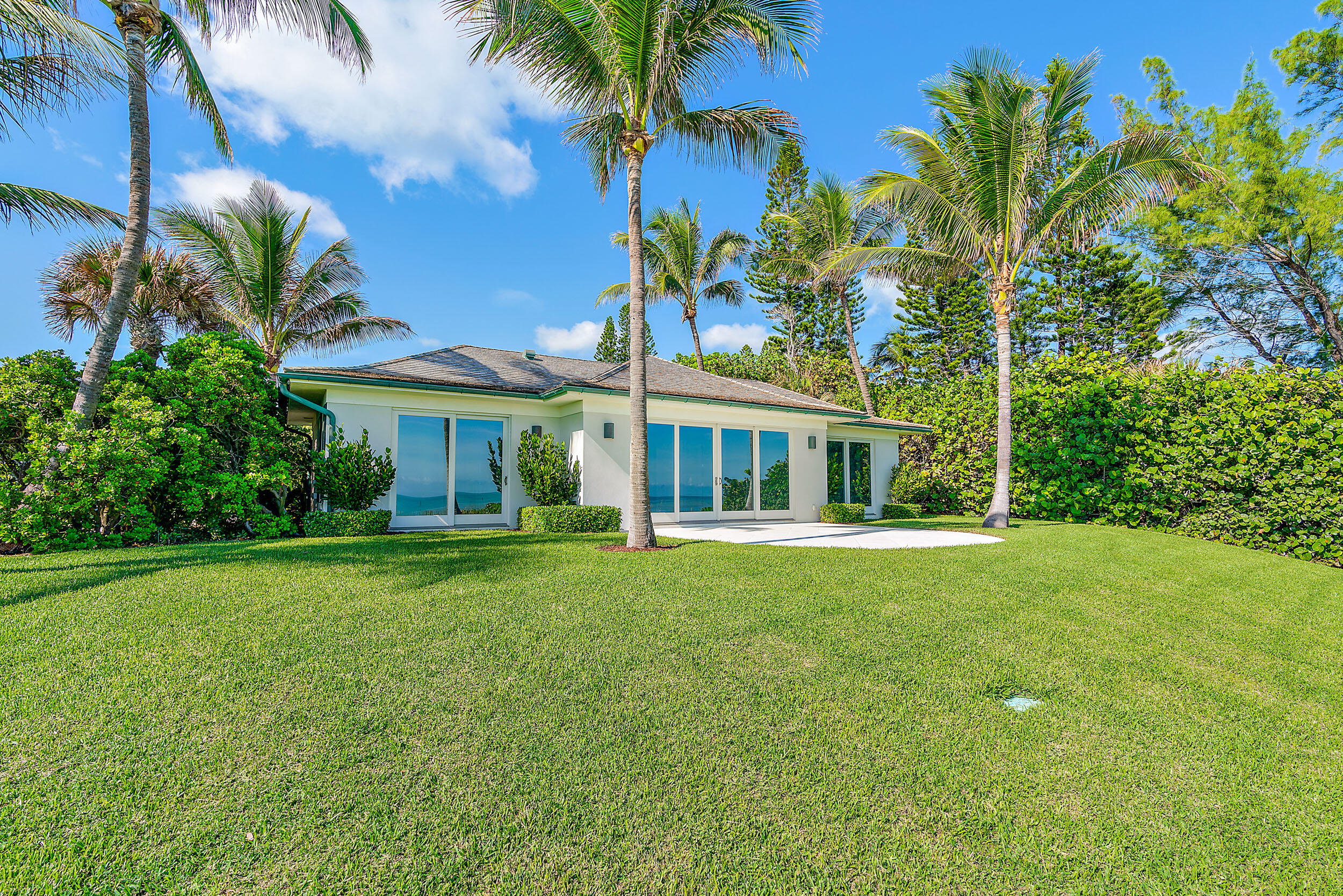 25 South Beach Road Hobe Sound, FL 33455 - Photo 23 of 28 a front view of a house with a garden