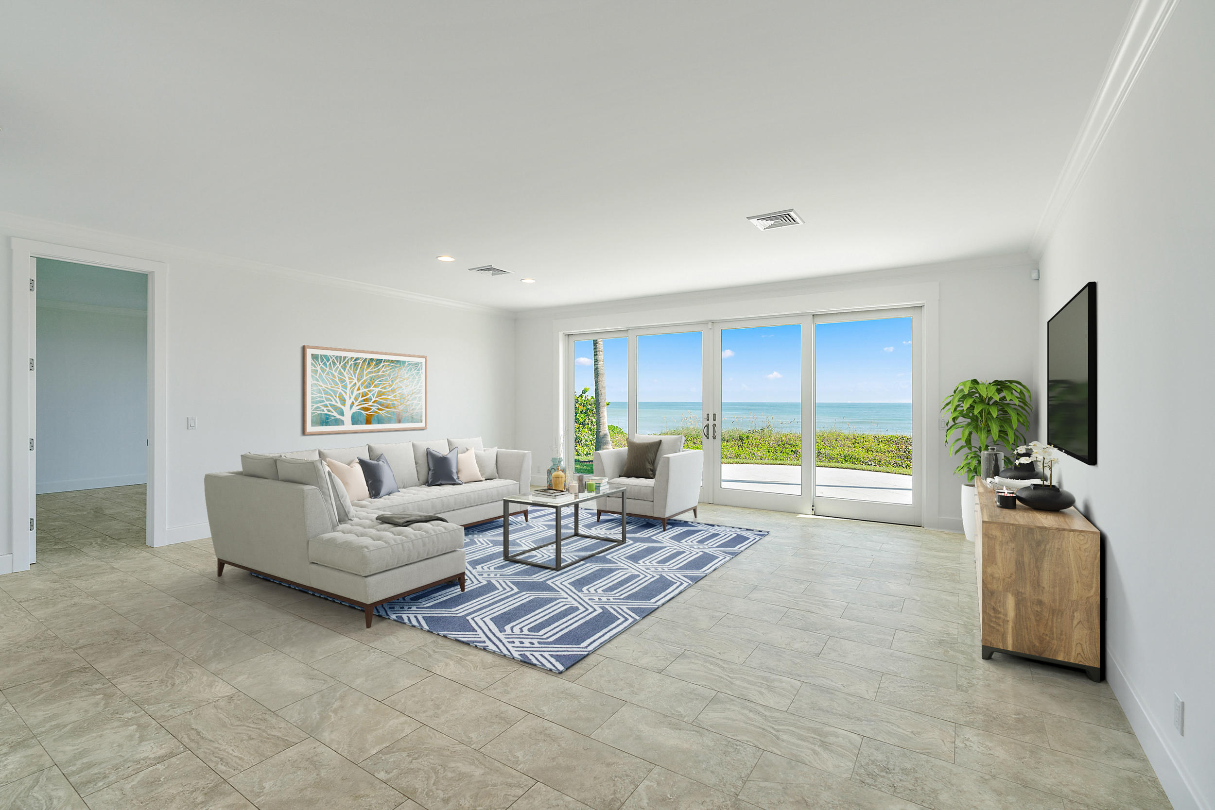 25 South Beach Road Hobe Sound, FL 33455 - Photo 25 of 28 a living room with furniture and a flat screen tv