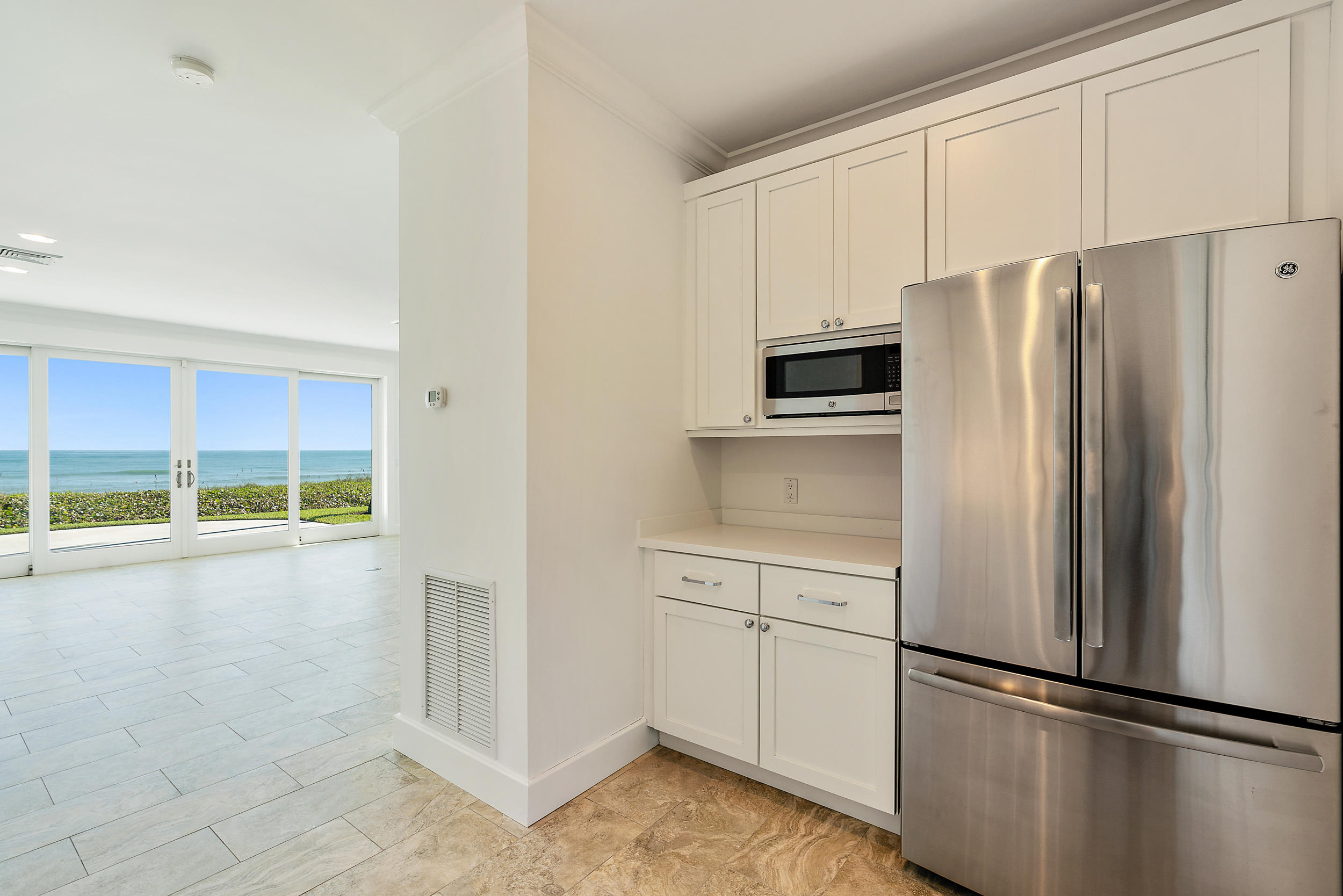 25 South Beach Road Hobe Sound, FL 33455 - Photo 27 of 28 a kitchen with stainless steel appliances a refrigerator sink and microwave