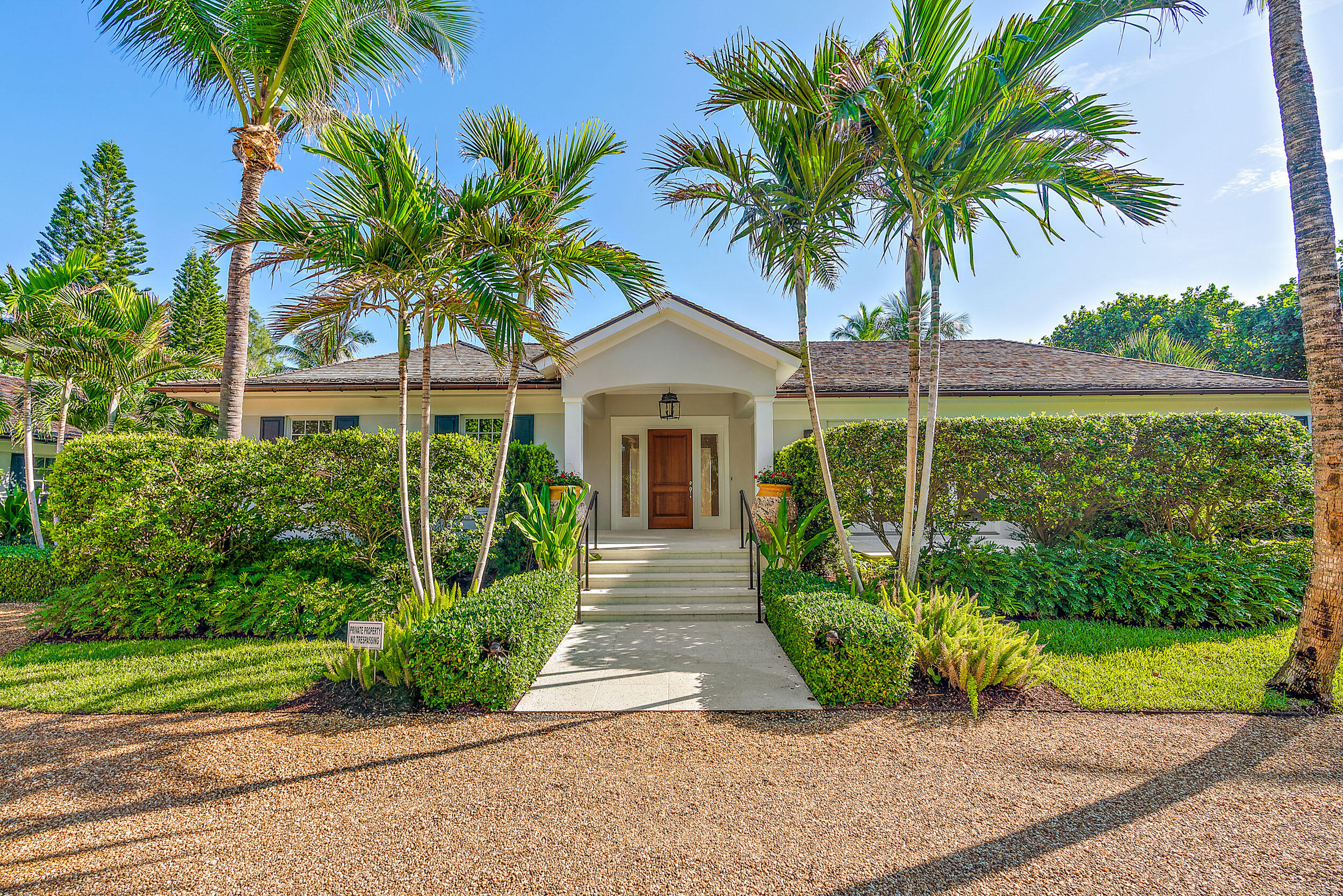 25 South Beach Road Hobe Sound, FL 33455 - Photo 5 of 28 a front view of a house with garden