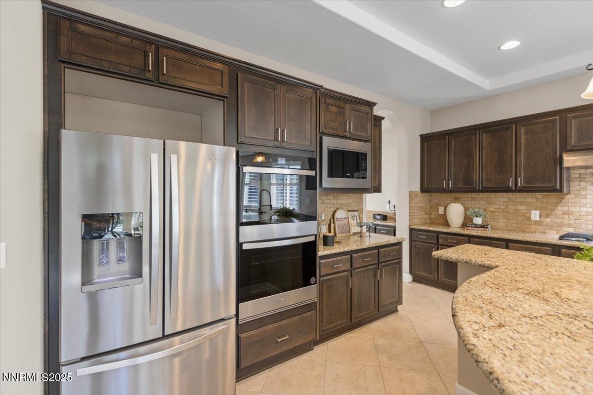 2675 Weymoor Court Reno, NV 89521 - Photo 25 of 75 a kitchen with stainless steel appliances granite countertop a refrigerator stove top oven and sink