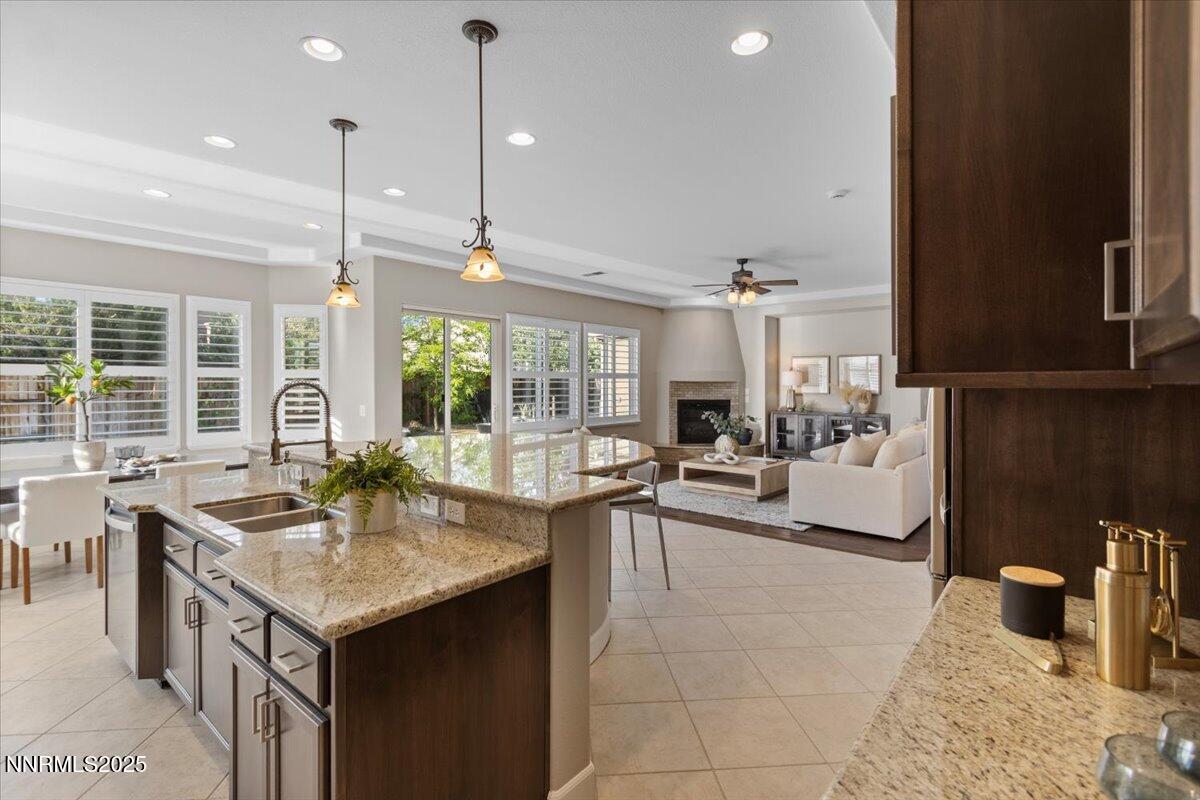 2675 Weymoor Court Reno, NV 89521 - Photo 27 of 75 a kitchen with a stove kitchen island a sink and living room view