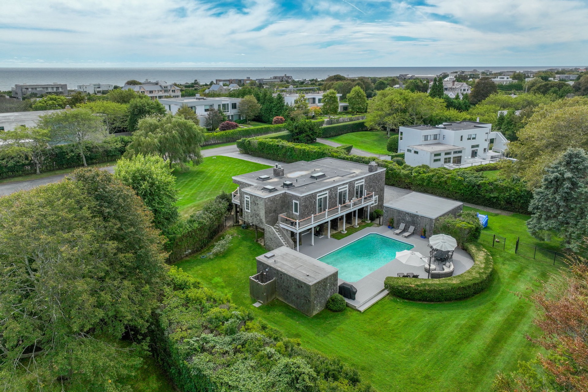 an aerial view of a house with garden space and street view