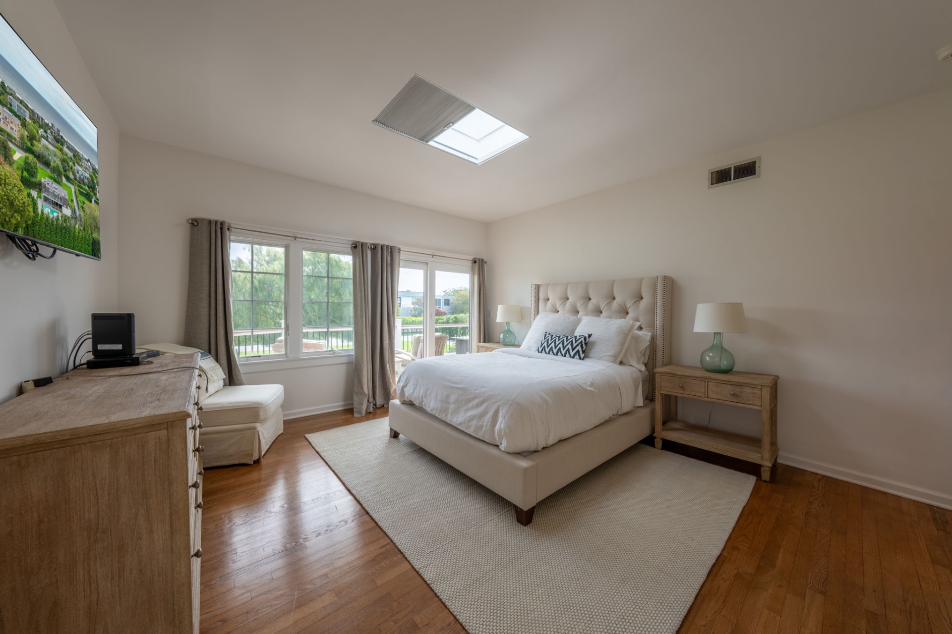 80 Sandpiper Lane Bridgehampton, NY 11932 - Photo 12 of 35 a bedroom with a balcony a bed and a couch