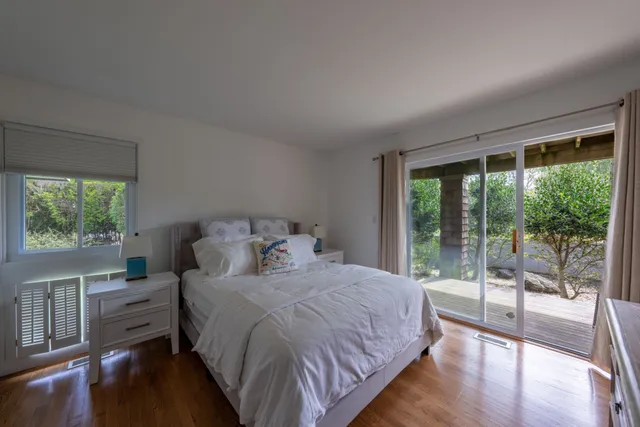 a bedroom with a large bed and a large window