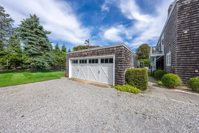 a view of a house with a yard and potted plants